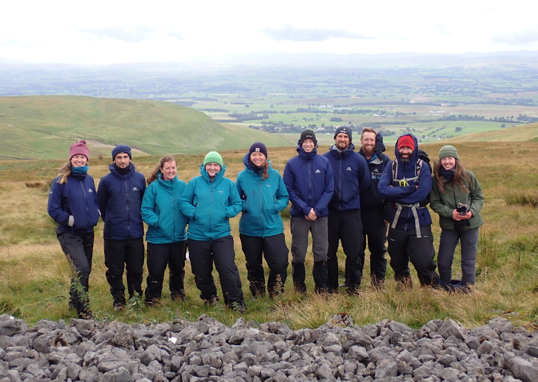 Group shot of peatland field officers on peatland. Dressed in winter clothes.