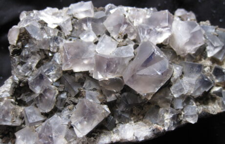 A rock covered in large, cubic crystals