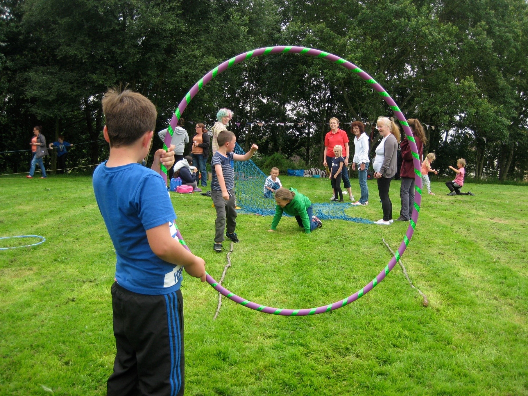 Image of children playing outdoors, one holding a hoop