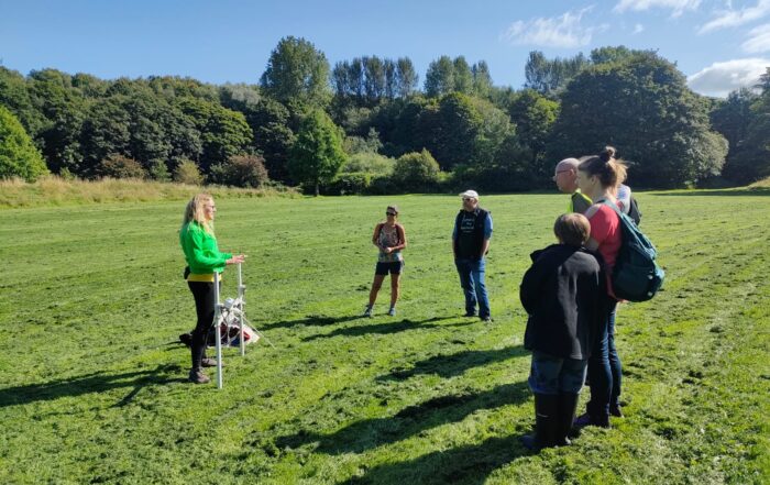 Group of people standing talking in a field