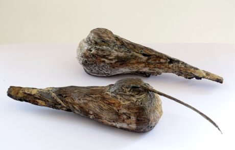 Photograph of two brown ceramic curlew