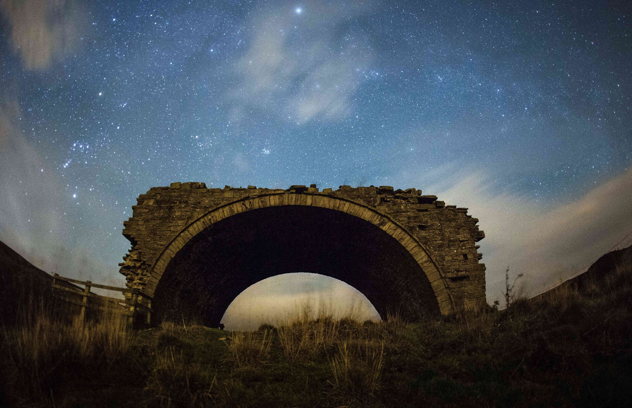 Rookhope Arch in the North Pennines, stone remains of chimney flue system and a starry blue sky.