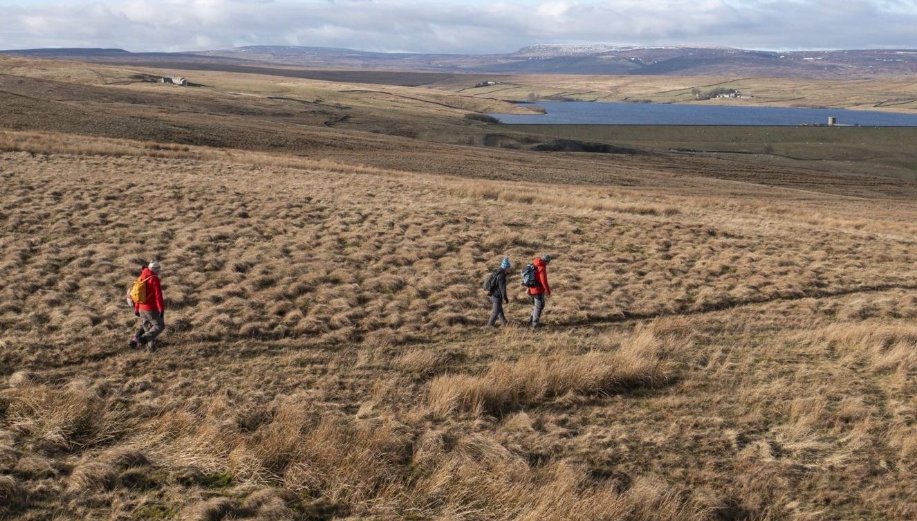 Walkers walking near Balderhead Reservoir on the Roof of England Walk.