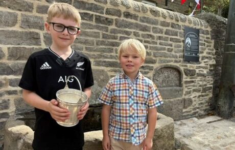 Isaacs Well restoration project Angus and William water in commemorative silver bucket